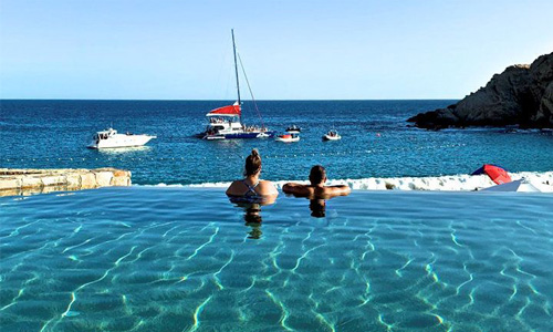 Picture of beautiful beach in Papagayo Gulf.  The picture shows  a couple looking into the ocean from the pool.